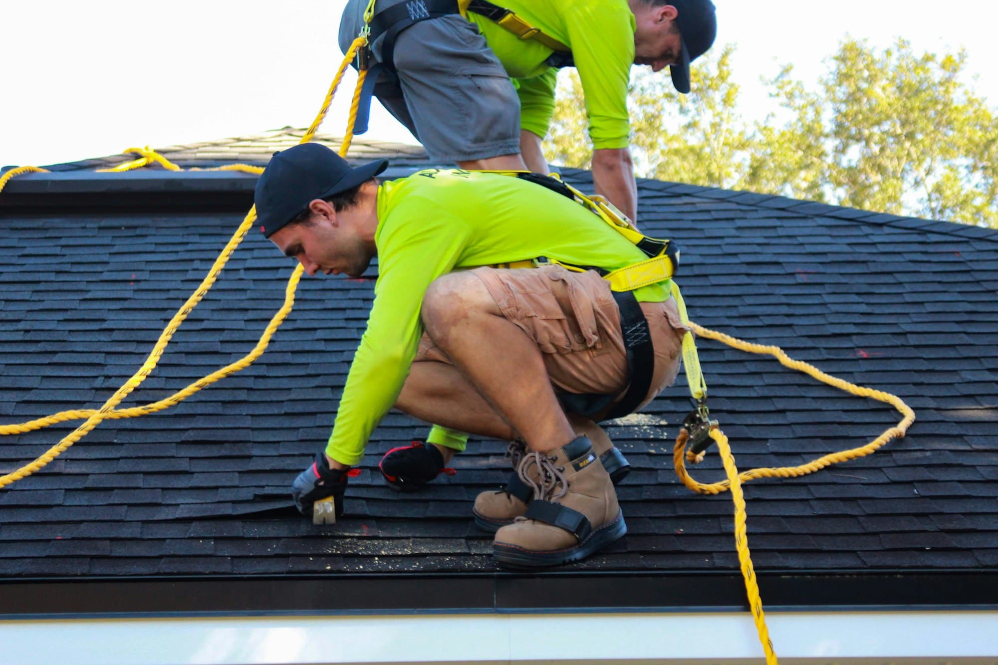 Two roofers working on a roof