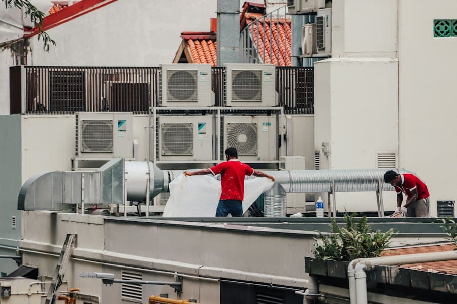 Technicians servicing rooftop AC units
