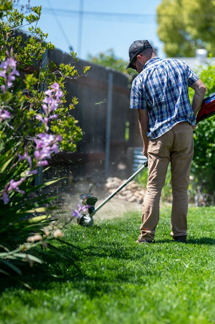 A landscaper trimming a lawn