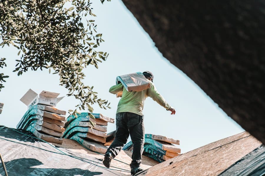 A roofer carrying shingles across a roof