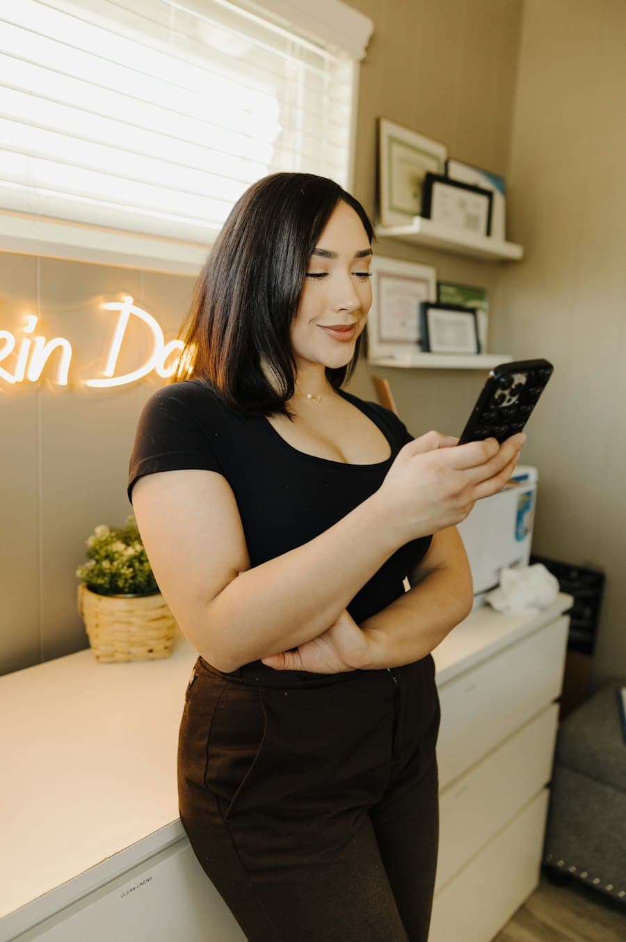 A salon owner checking her phone